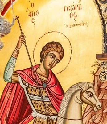 Interior of a Greek Orthodox church featuring Byzantine iconography on the ceiling