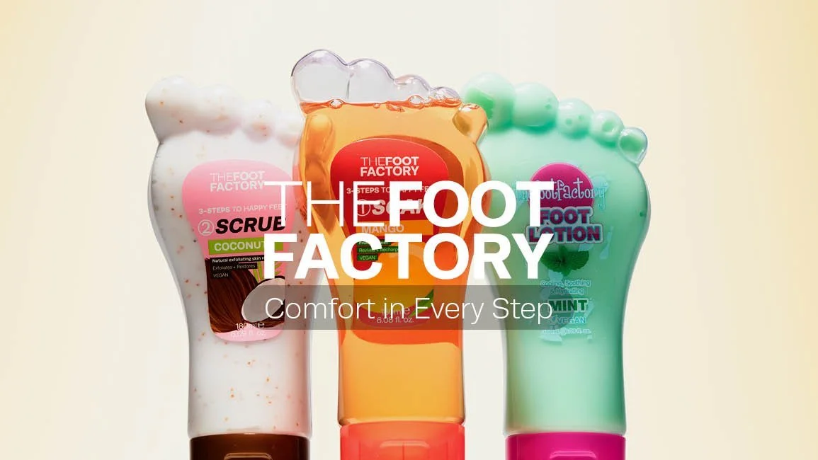 Three bottles of foot care products with colorful caps and packaging, branded as The Foot Factory, positioned side by side against a plain background.