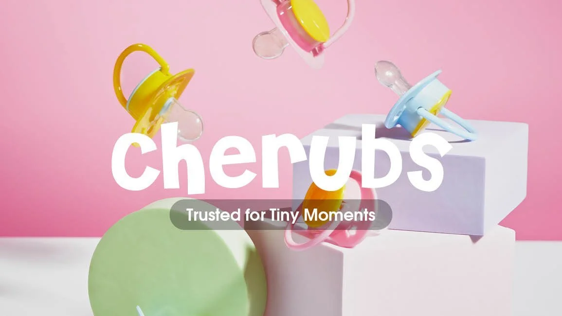 Colorful baby pacifiers and teething toys on a pastel pink background with the word 'cherrubs' and the slogan 'Trusted for Tiny Moments'.