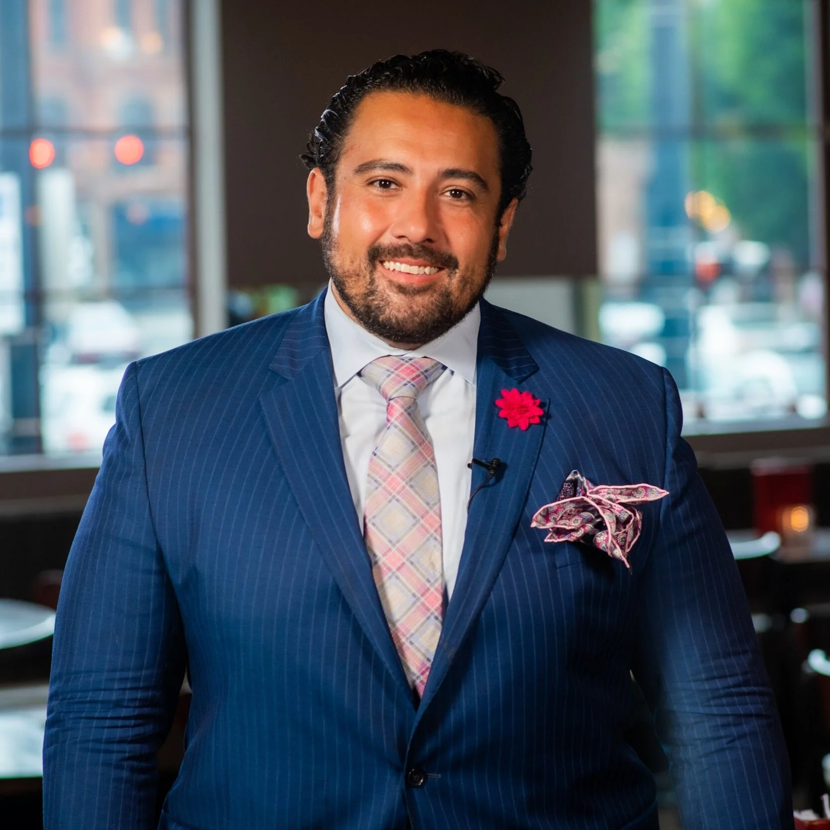 Dominick Purnomo smiling in a blue suit