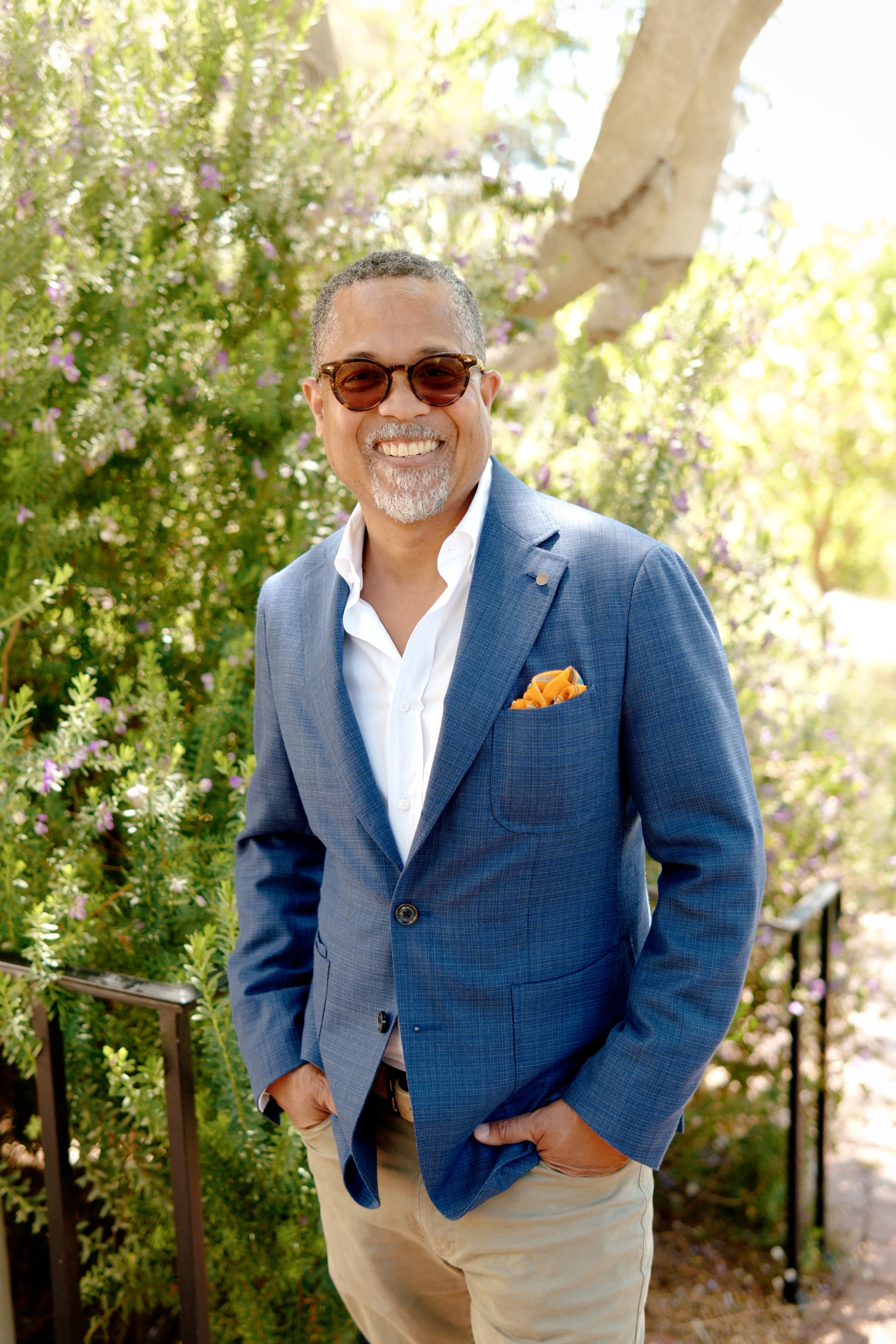 Gary Obligacion smiling outdoors in sunglasses and a blue blazer