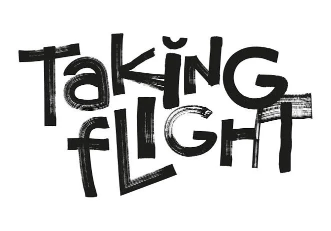 a black and white logo written in marker style pen, that reads 'Taking Flight'.