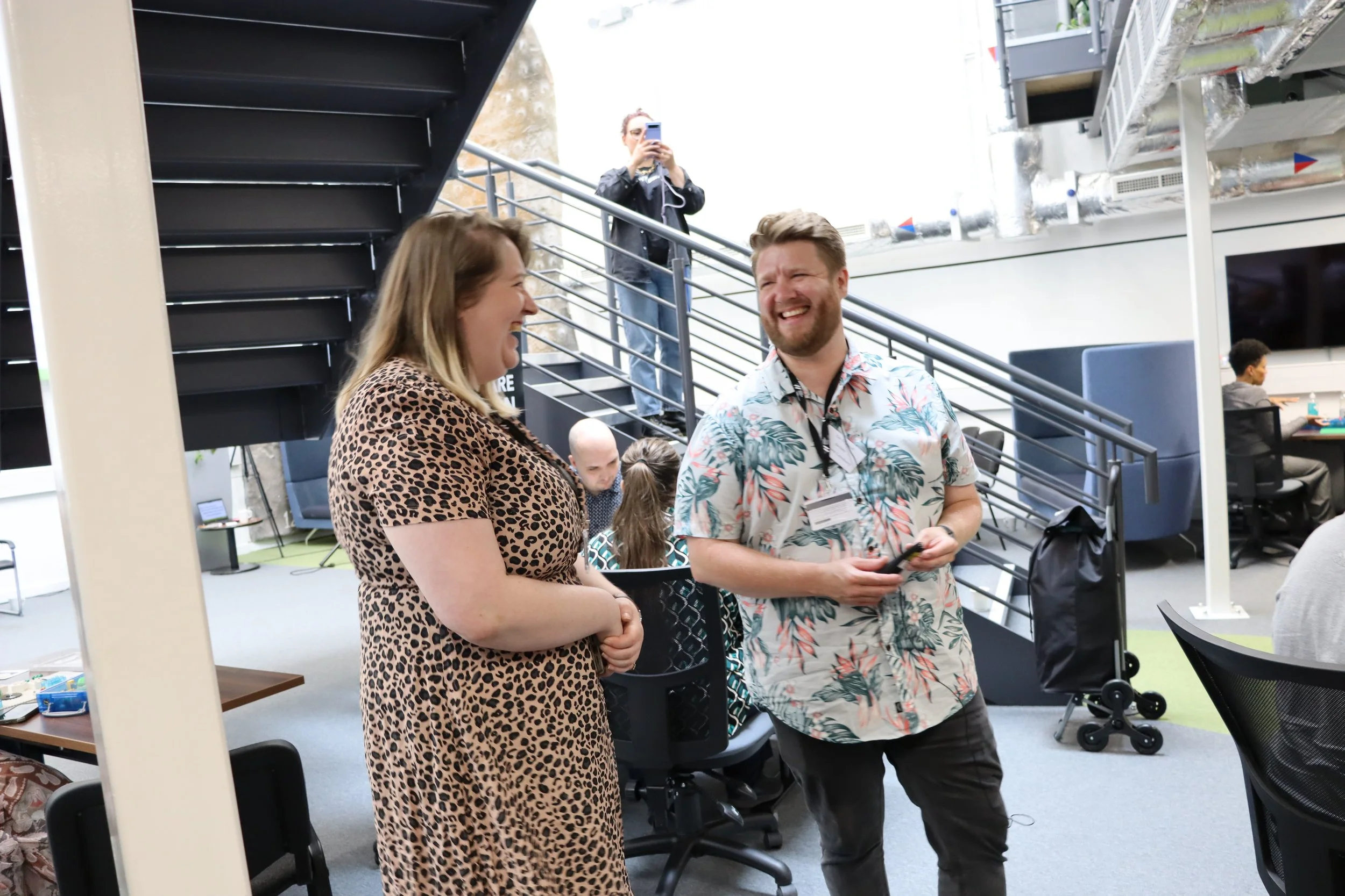 SIC's CEO Alice stands laughing with team member Dan