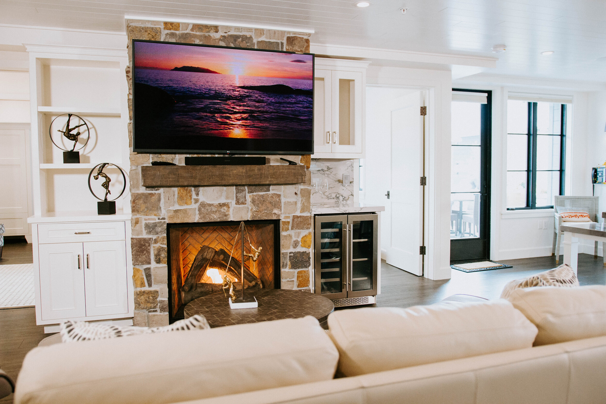 Flatscreen TV over Fireplace with View to Courtyard