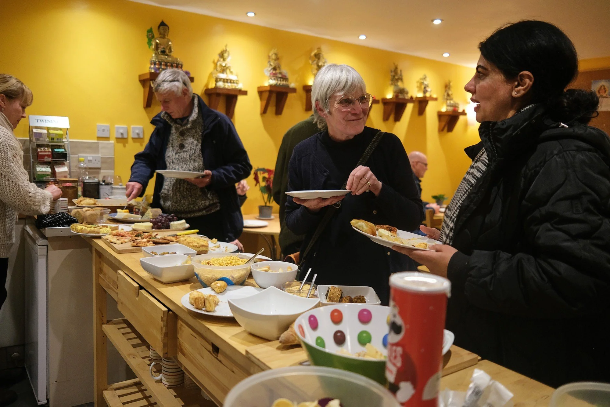 Food and conversation at the Candlelight Prayers community social in 2022.