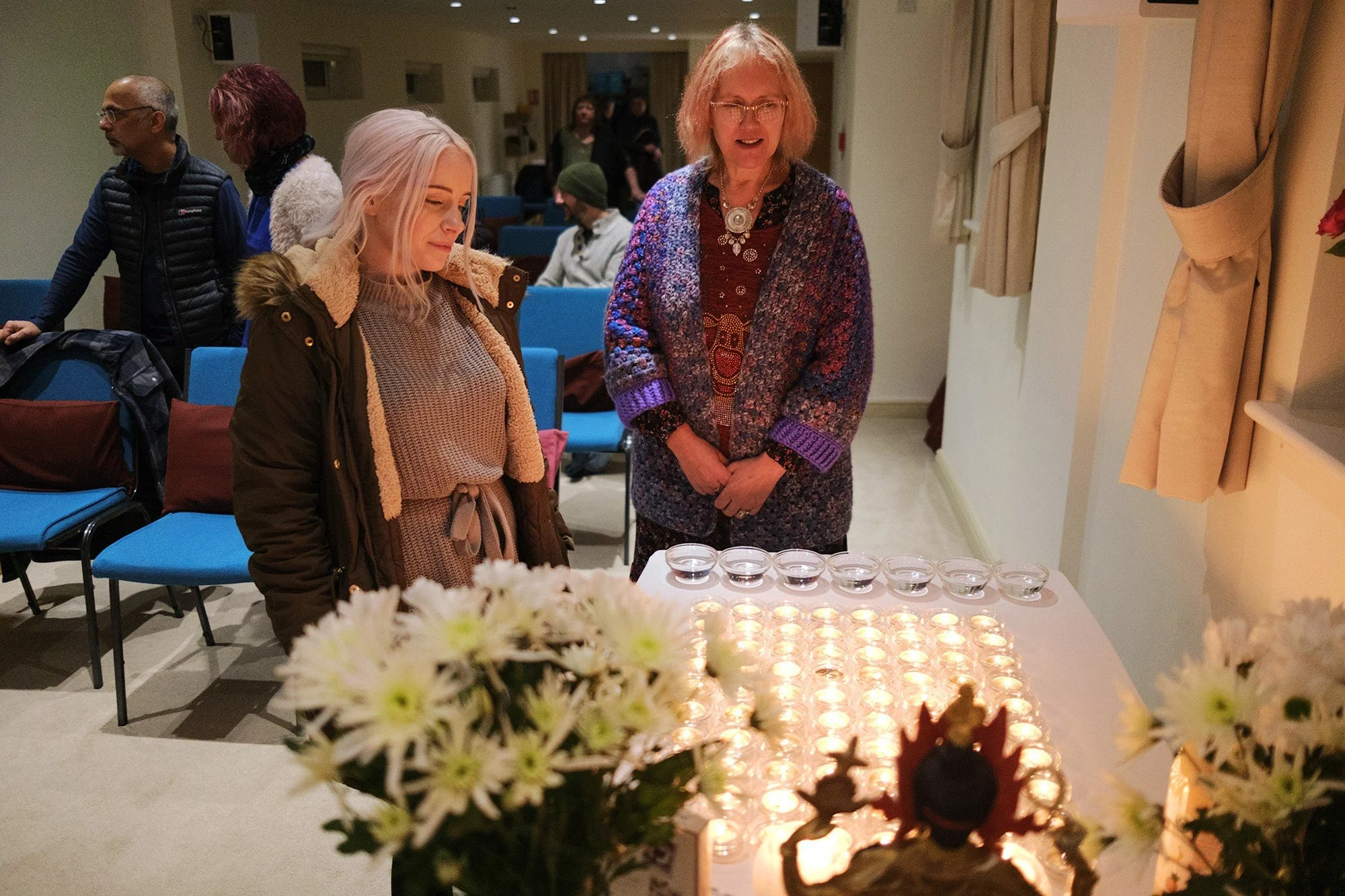 Visitors beside the candle offerings at Candlelight Prayers in 2023.