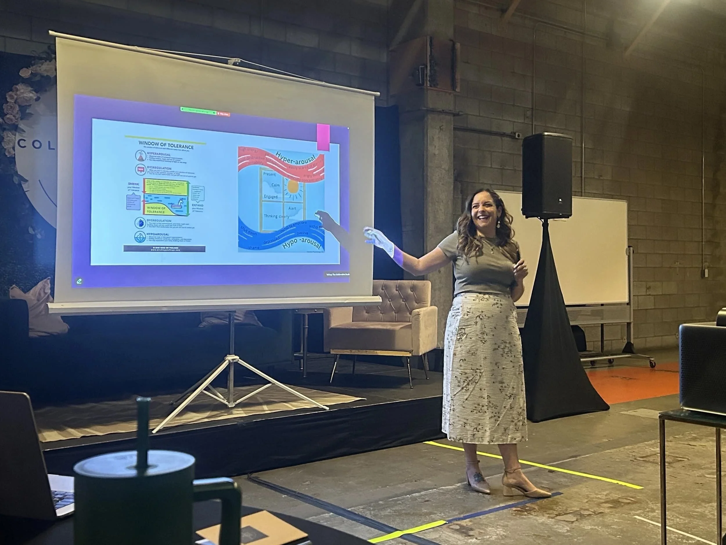 A woman gives a presentation on grief, trauma, and loss at The Collaborative Doula Conference in London, Ontario.