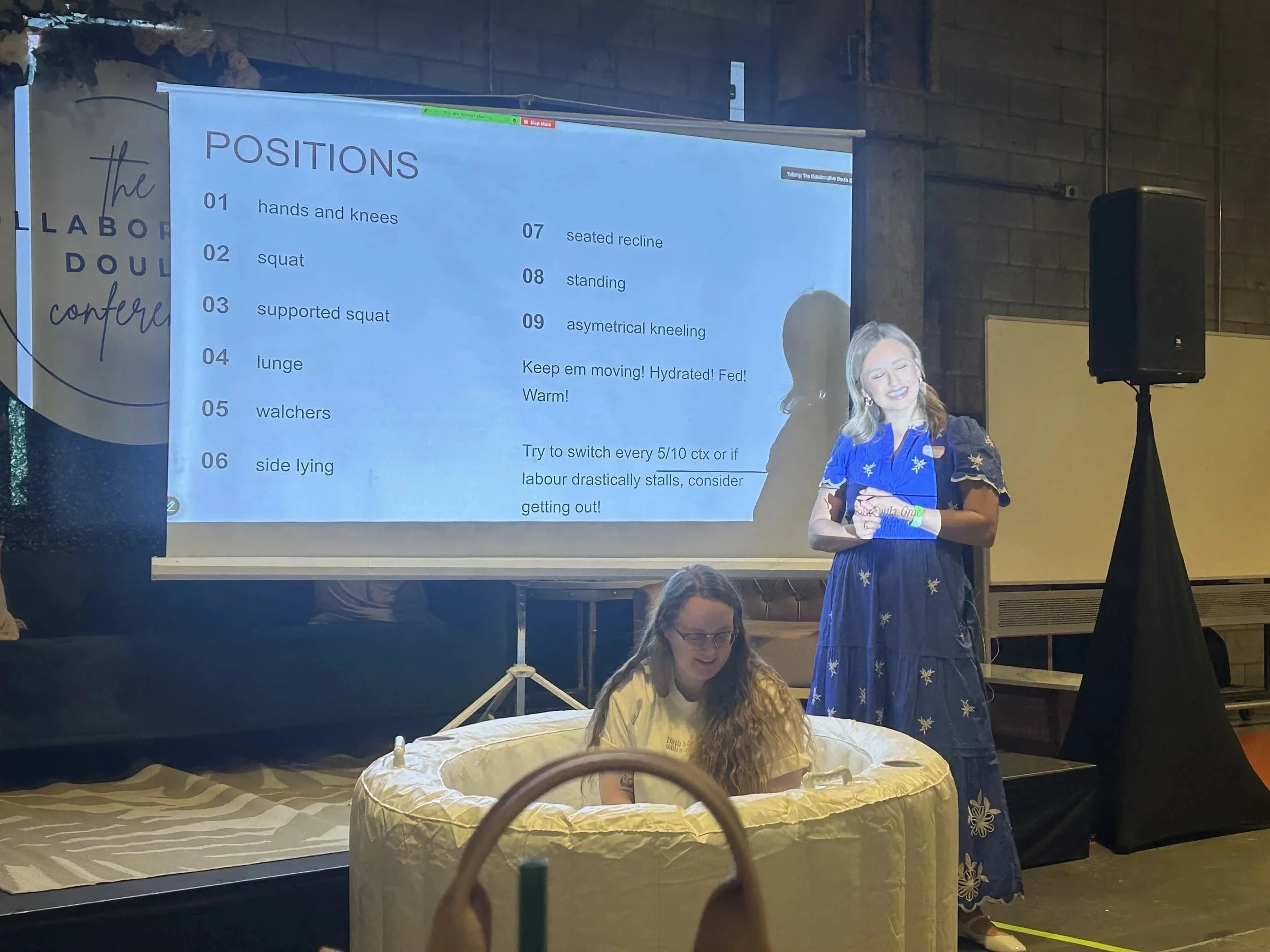Amy Silva assists a pregnant client in her birth support services by guiding her through an exercise on a yoga ball at The Collaborative Doula Conference in London, Ontario.