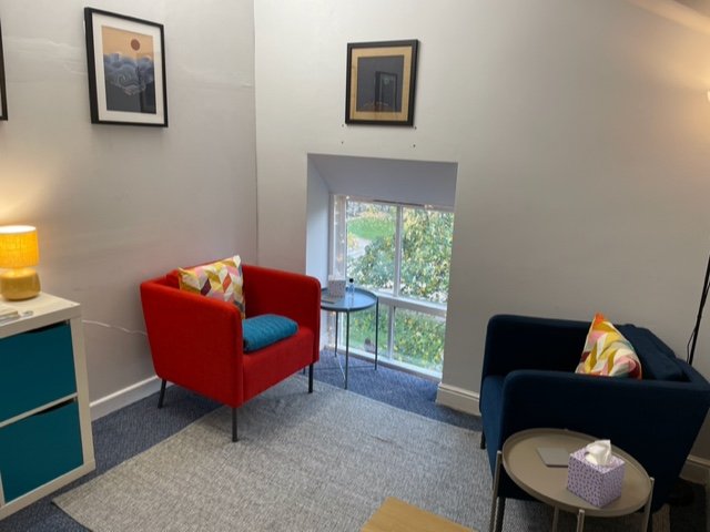Counselling room in Glossop with two armchairs and small table and a lamp.