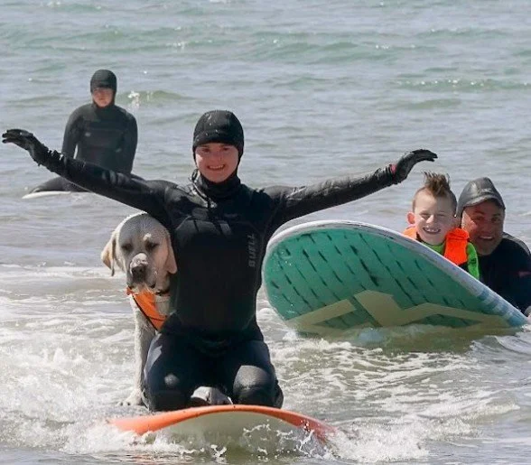 Pancho and student athelete catching waves on a Saturday