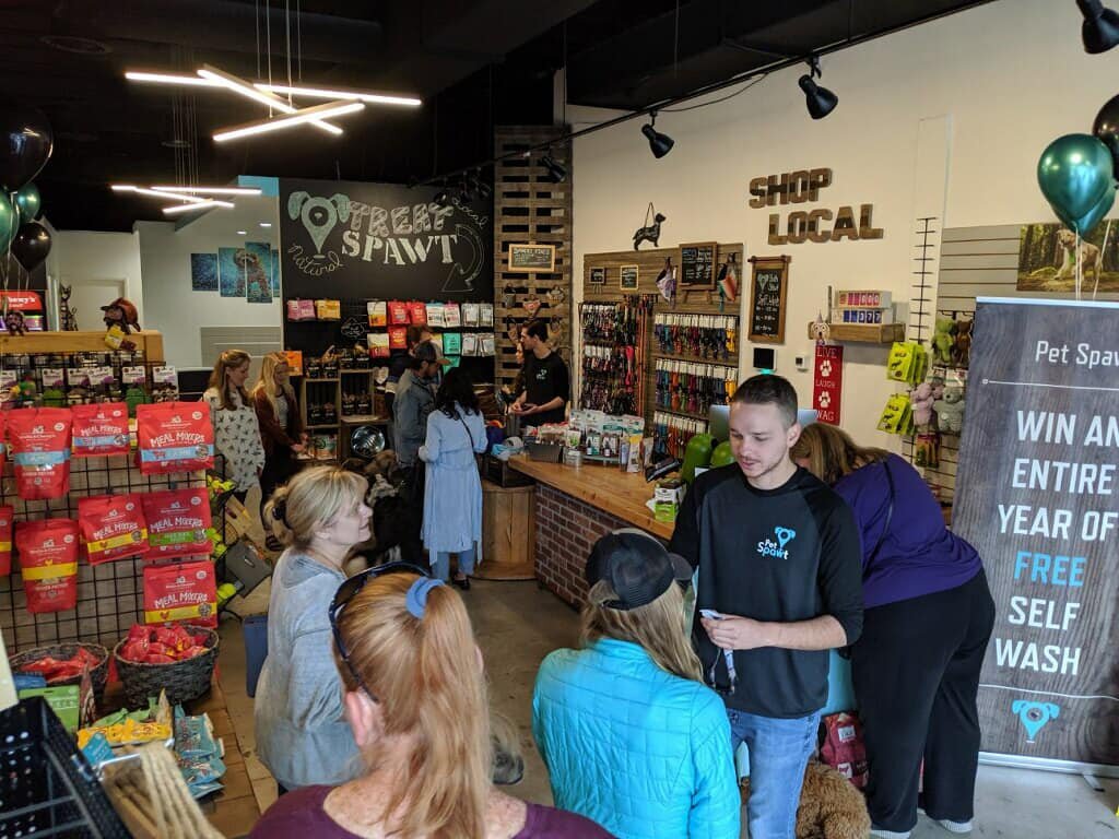 A crowd chats inside Pet Spawt, a boutique pet store in Salt Lake