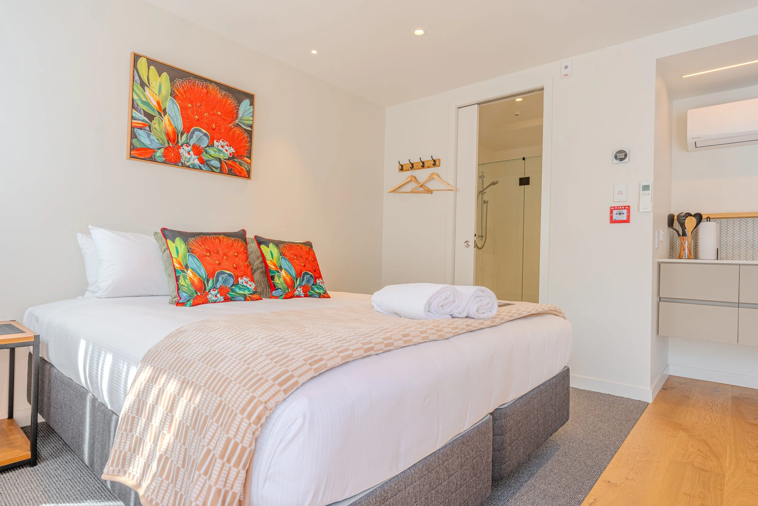 Comfortable guest room with a queen bed, ensuite bathroom, and contemporary furnishings.