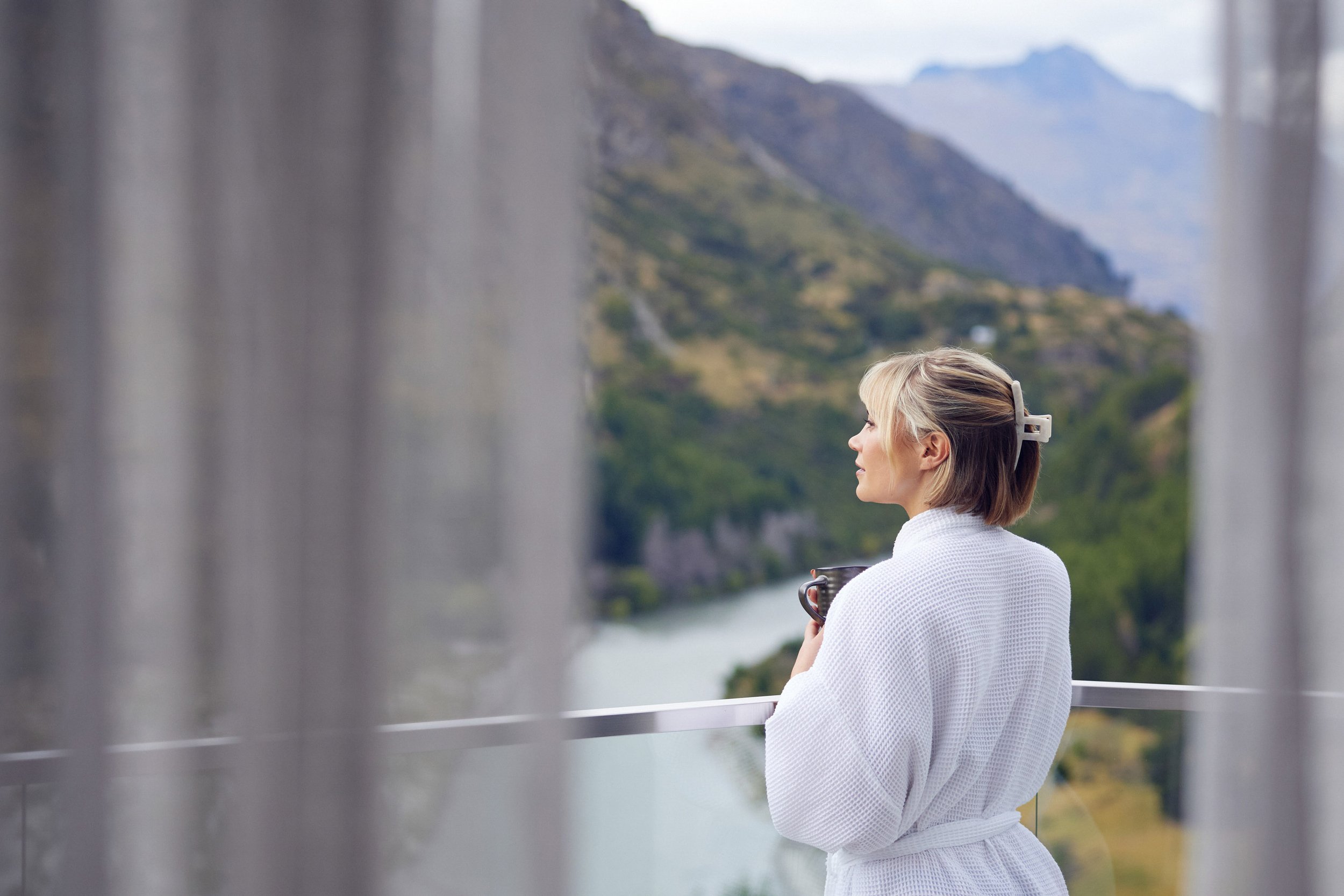 Woman looking over the shotover view by the balcony