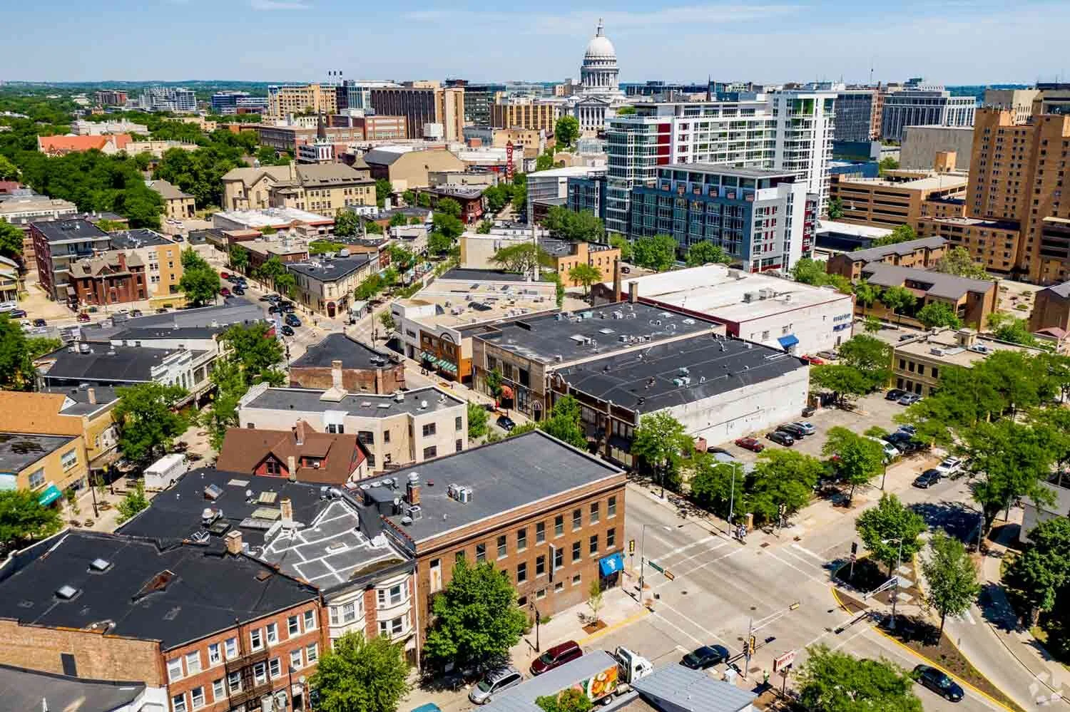 An aeriall view of the red brick building with blue awnings at 320-328 West Gorham Street, Madison, WI 53703.