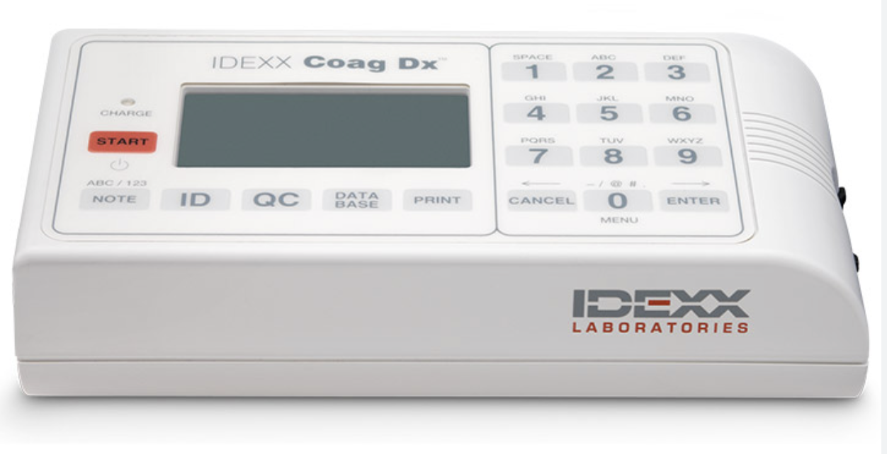 A medical laboratory coagulometer device with a digital display screen, keypad, and various control buttons, labeled 'IDEXX Coag Dx.'
