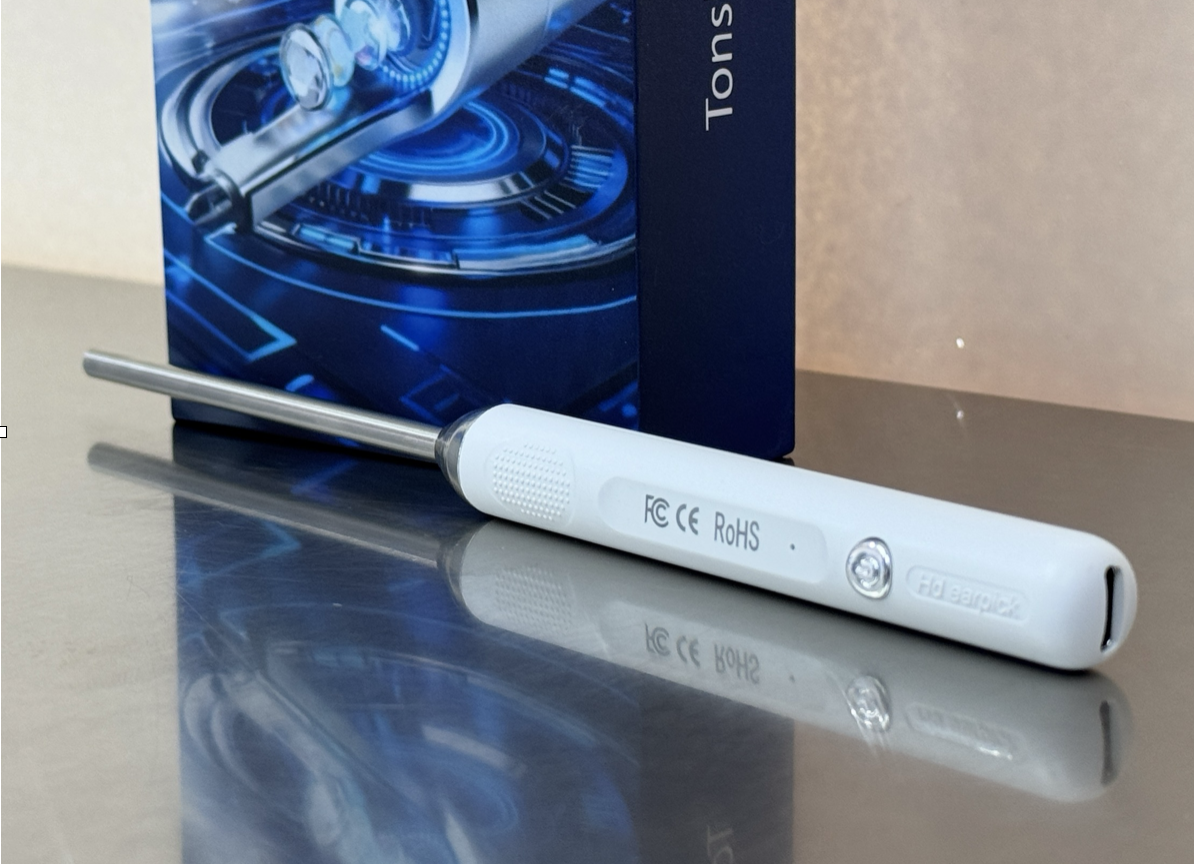 A portable mini endoscope device lying on a reflective surface, with a blue box in the background.