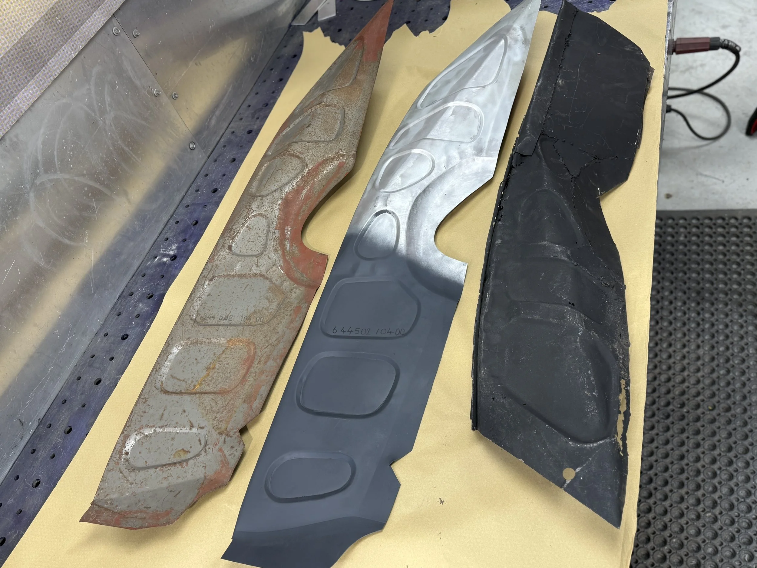 Porsche 356 a inner front luggage panel. The top panel is genuine Porsche loaned to us by PRS 356. The bottom panel is all that remains of the original. Both panels were used to fabricate a replacement from scratch as the aftermarket panels do not ha