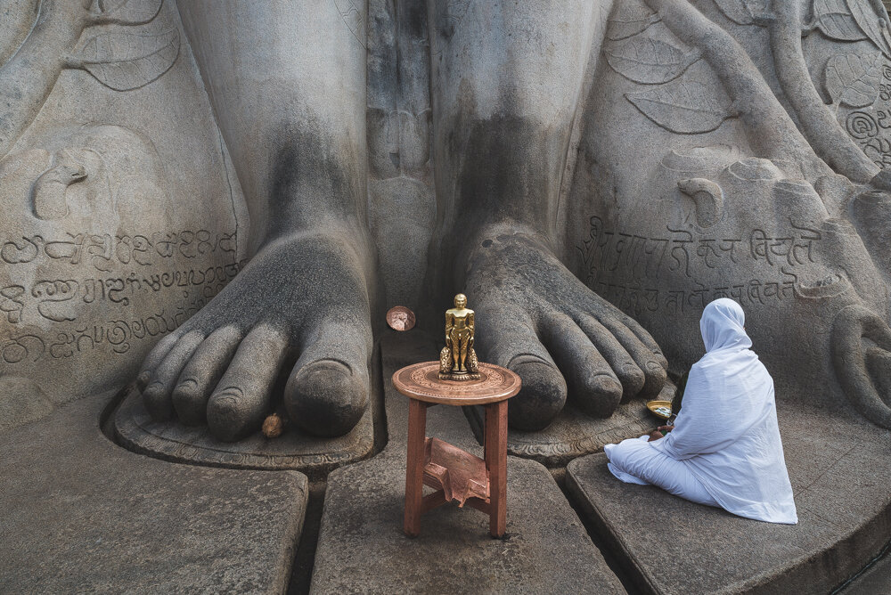 una devota ai piedi della statua