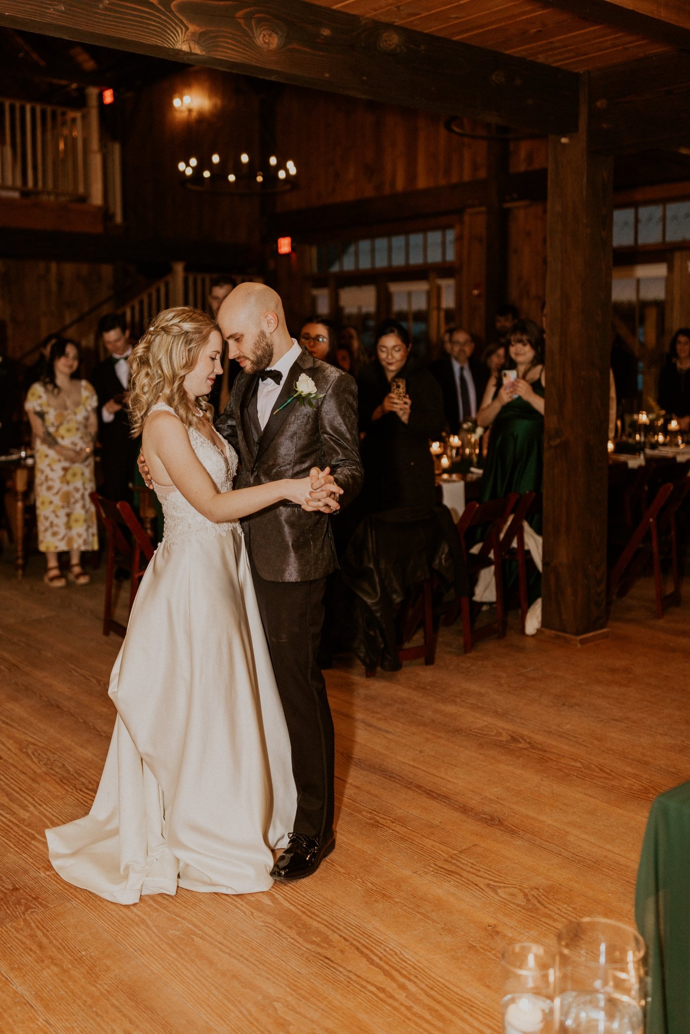bride and groom first dance in barn