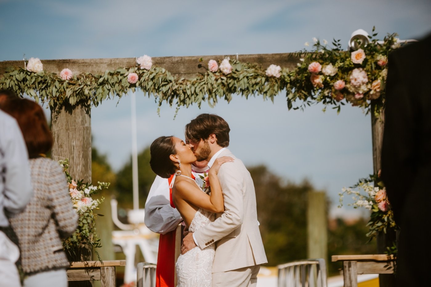 waterfront wedding ceremony with floral arch