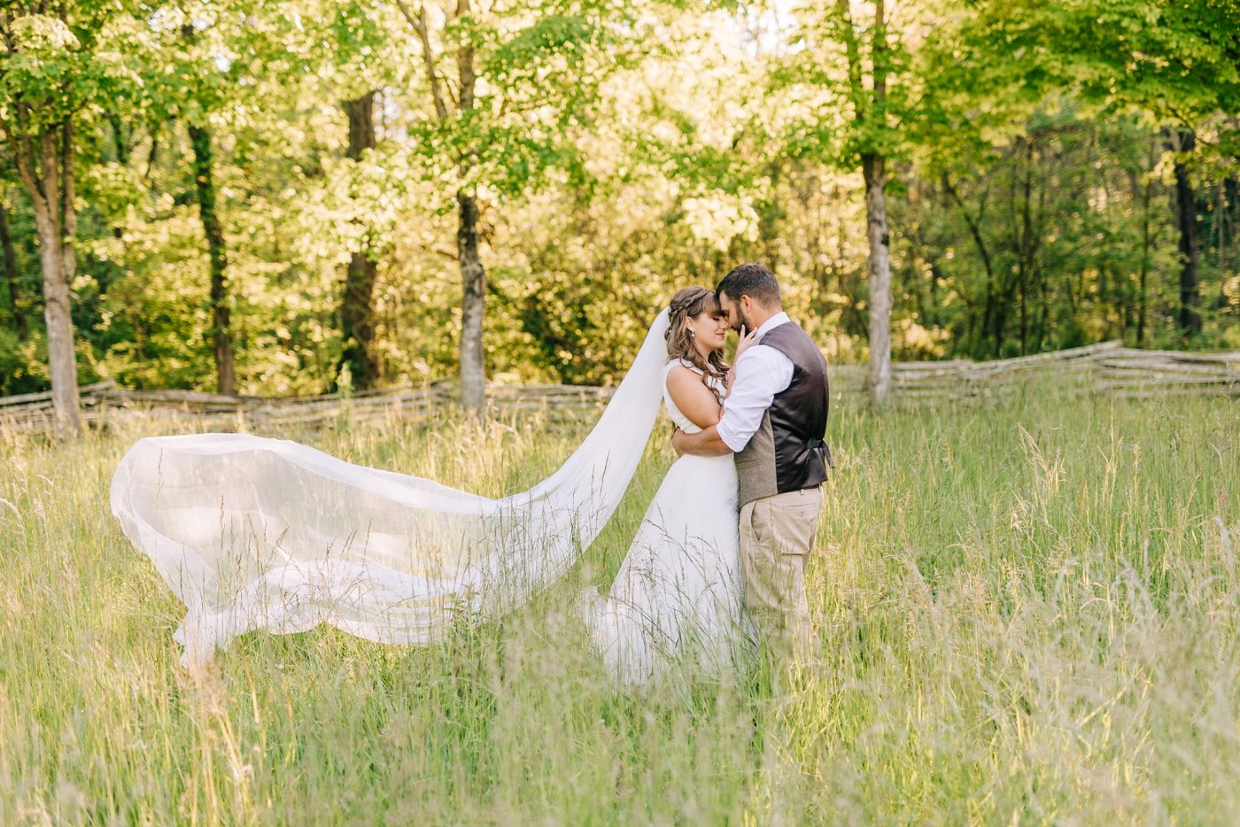 bride and groom in field for portraits