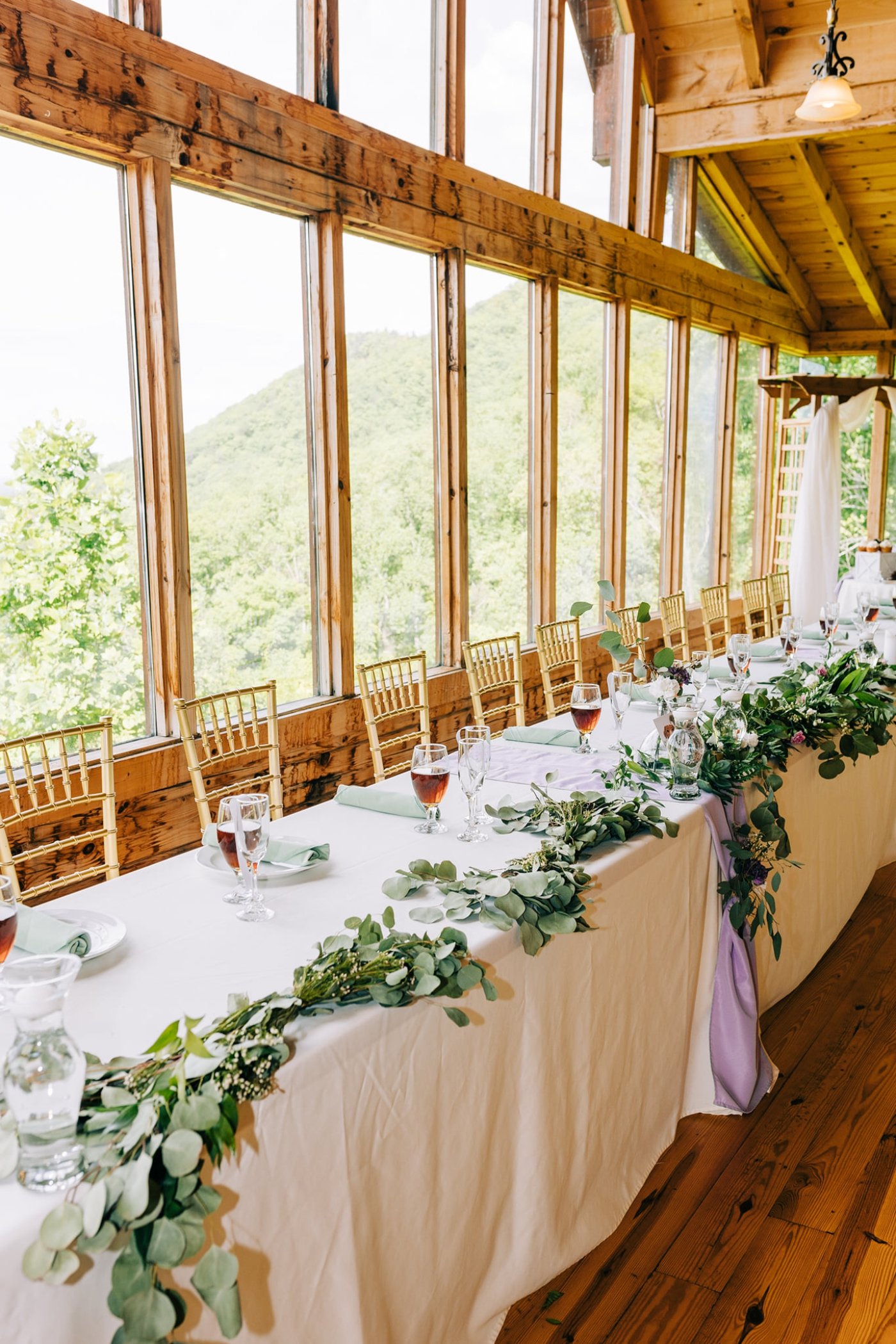 head table with greenery and white flowers