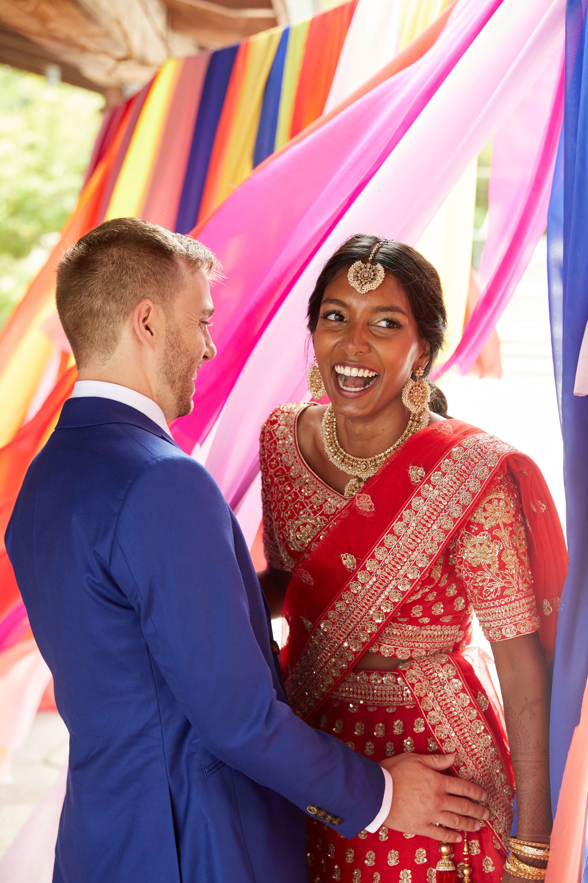 bride and groom portraits with colorful fabric