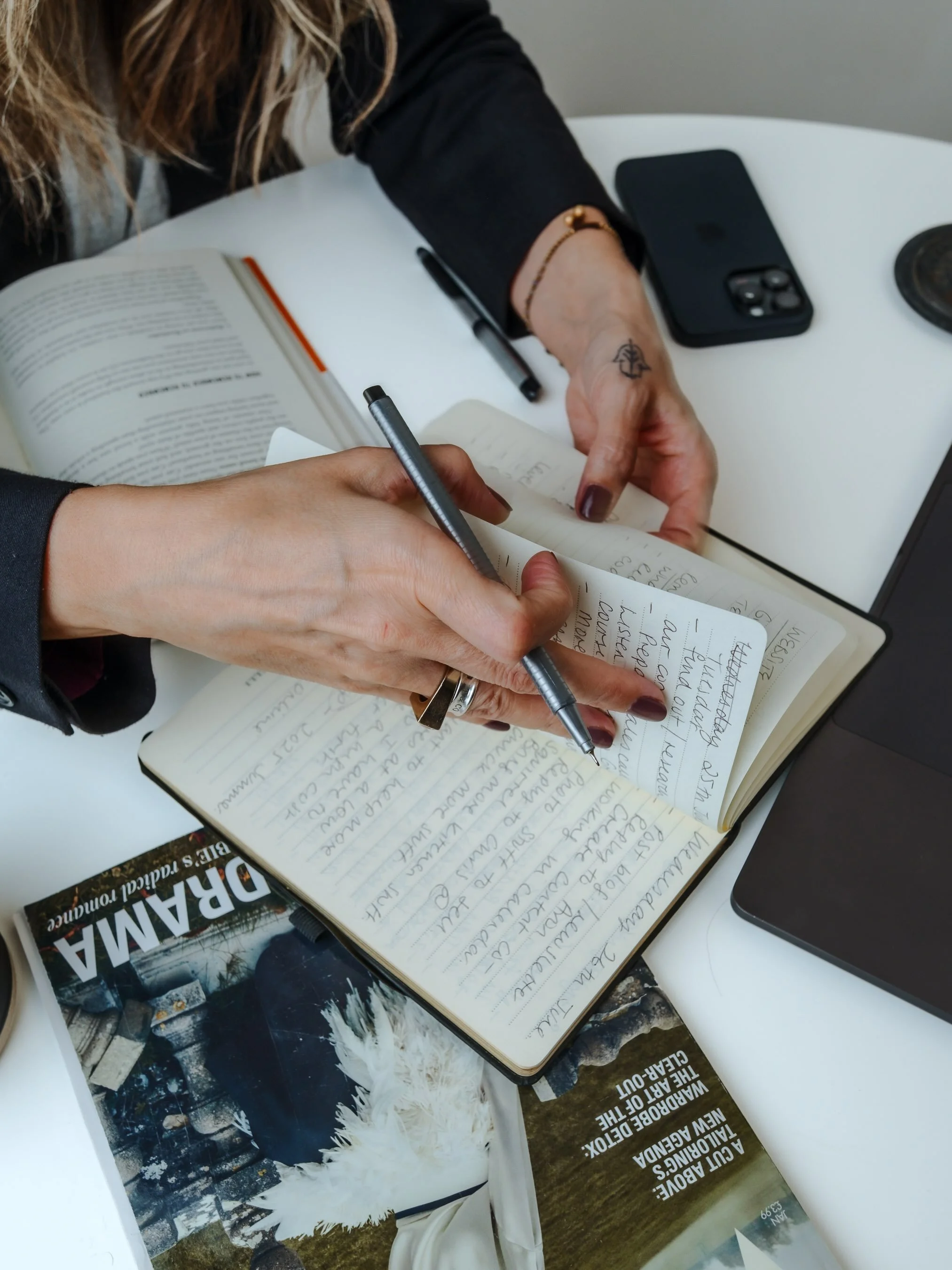 Rosie Harriott making notes while working on her fashion consultancy business
