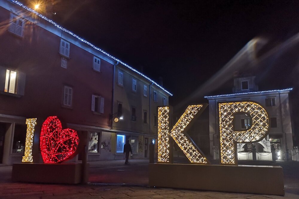 Christmas lights and sign (KP is abbreviation for Koper) outside Andrew’ Koper apartment