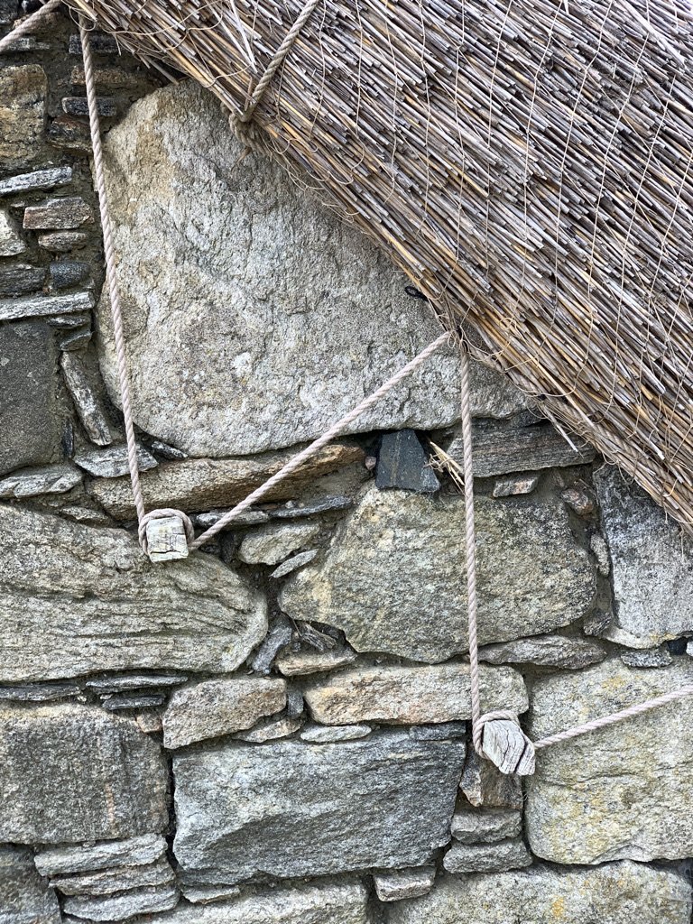 Thatch roof tied down by rope