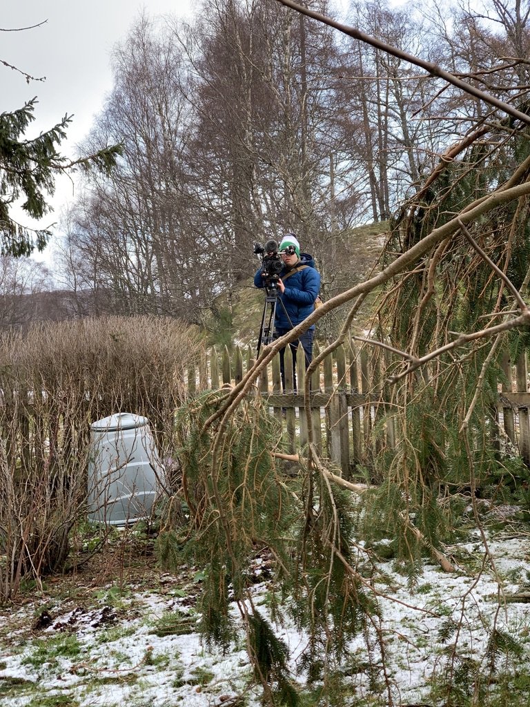 A reporter from the BBC films the clean-up for the evening news report.