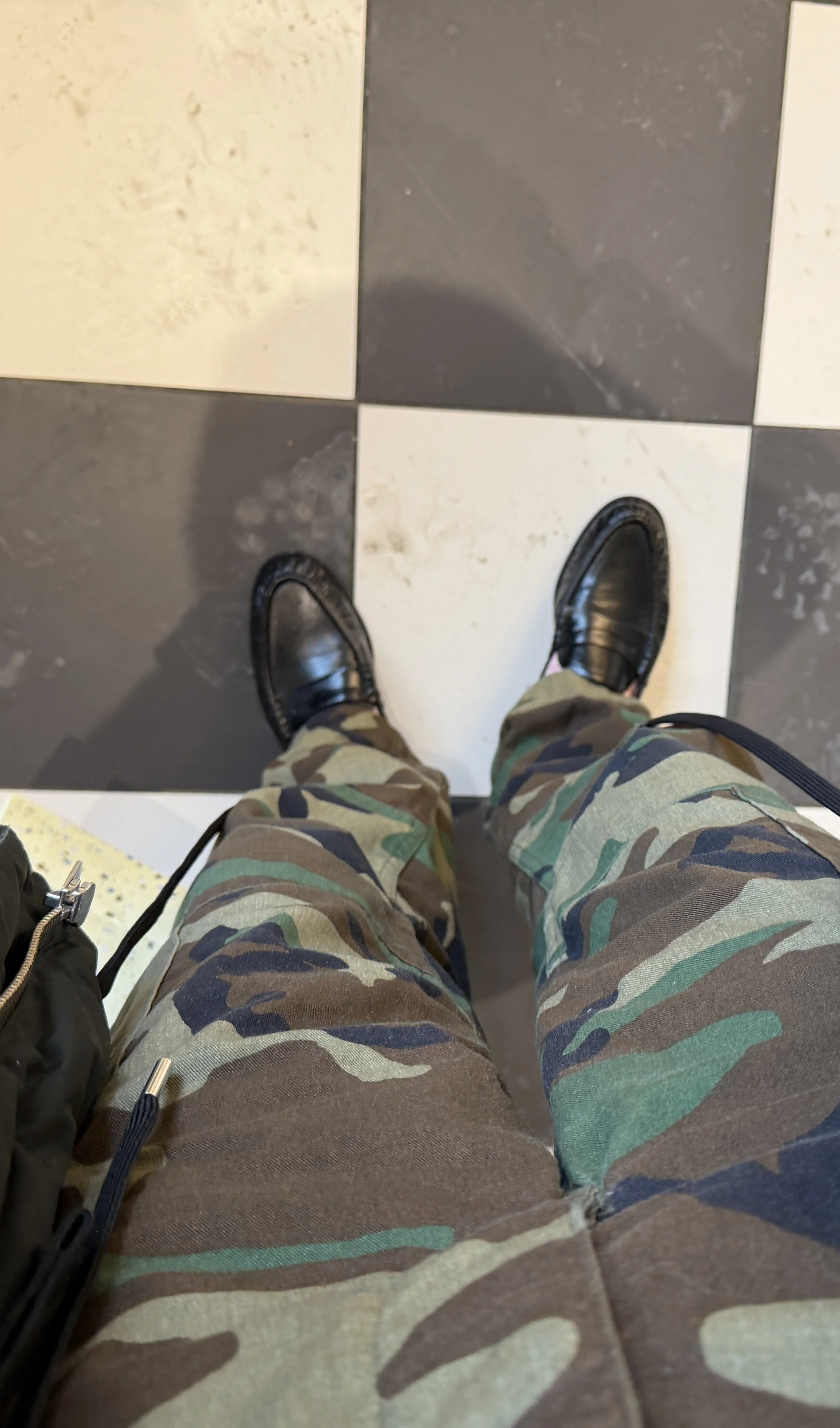 Uncuffed camo pants styled with slim loafers for a lunch date outfit