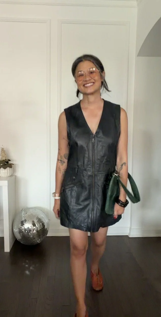 Daytime styling idea for a black leather mini dress with red moccasins and a teal handbag.