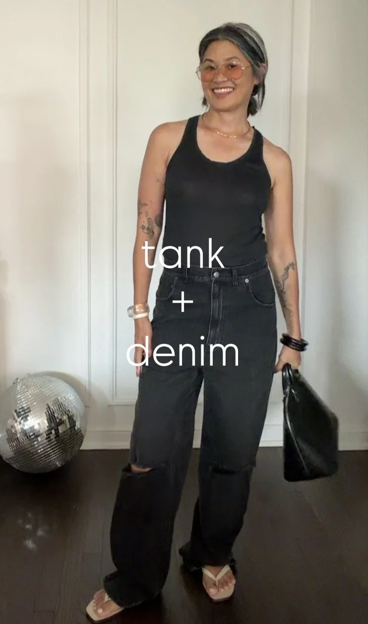 Chic all-black summer outfit featuring black denim and a fitted black tank.