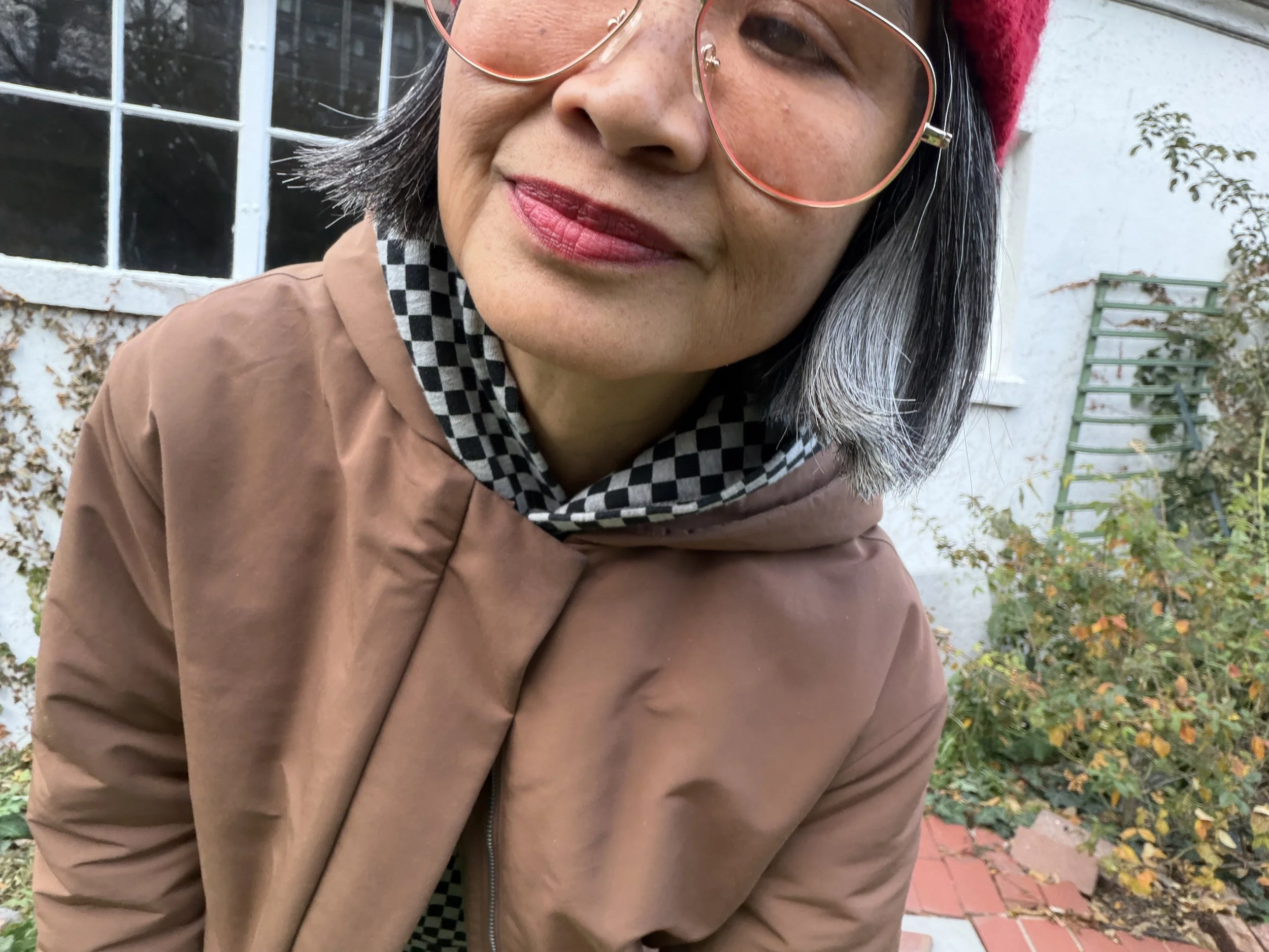 Checkerboard hoodie sweatshirt styled with neutral layers for a modern fall outfit — chic style over 50
