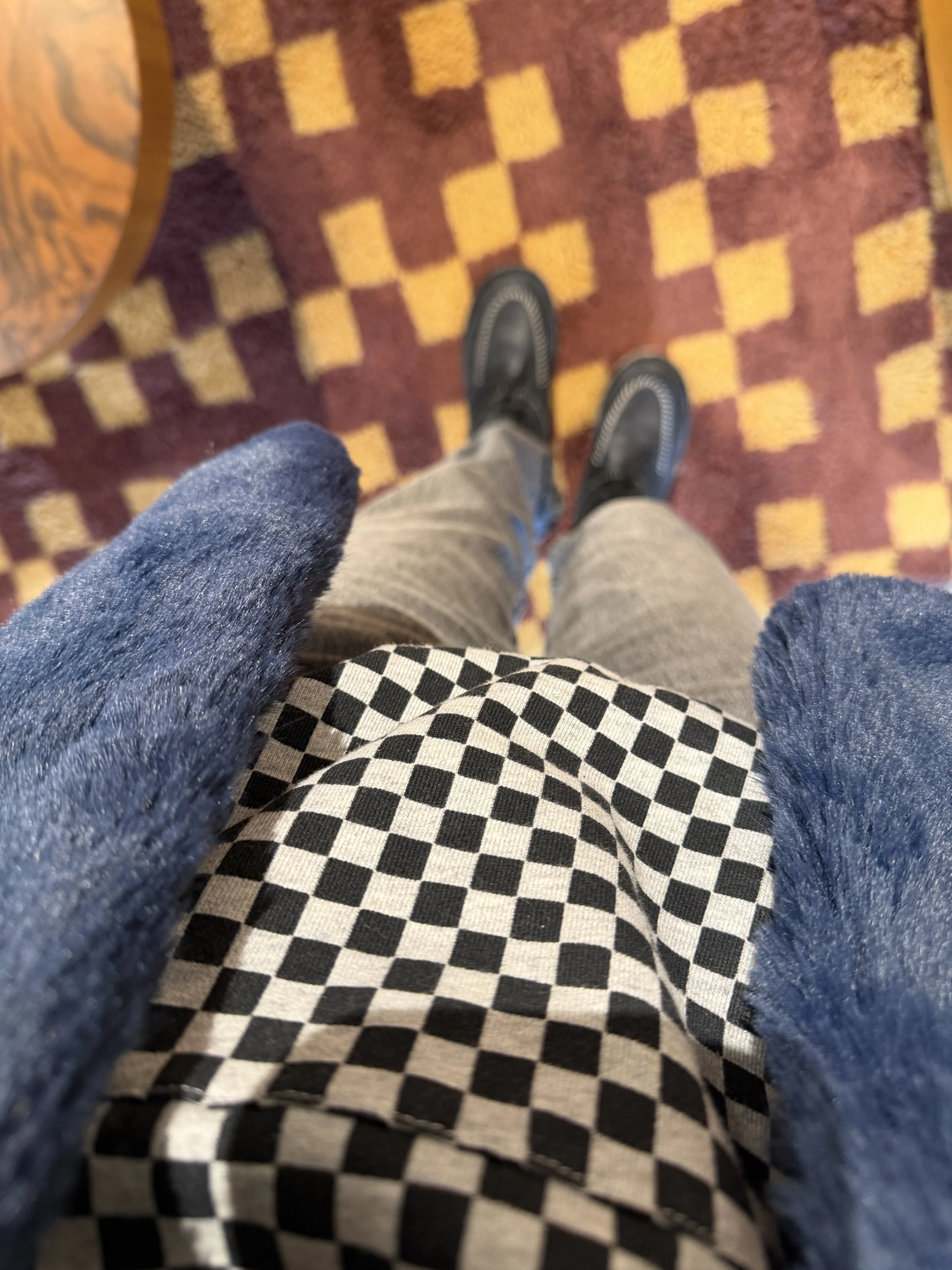 Close-up of checkerboard fabric texture styled for fall and winter layering