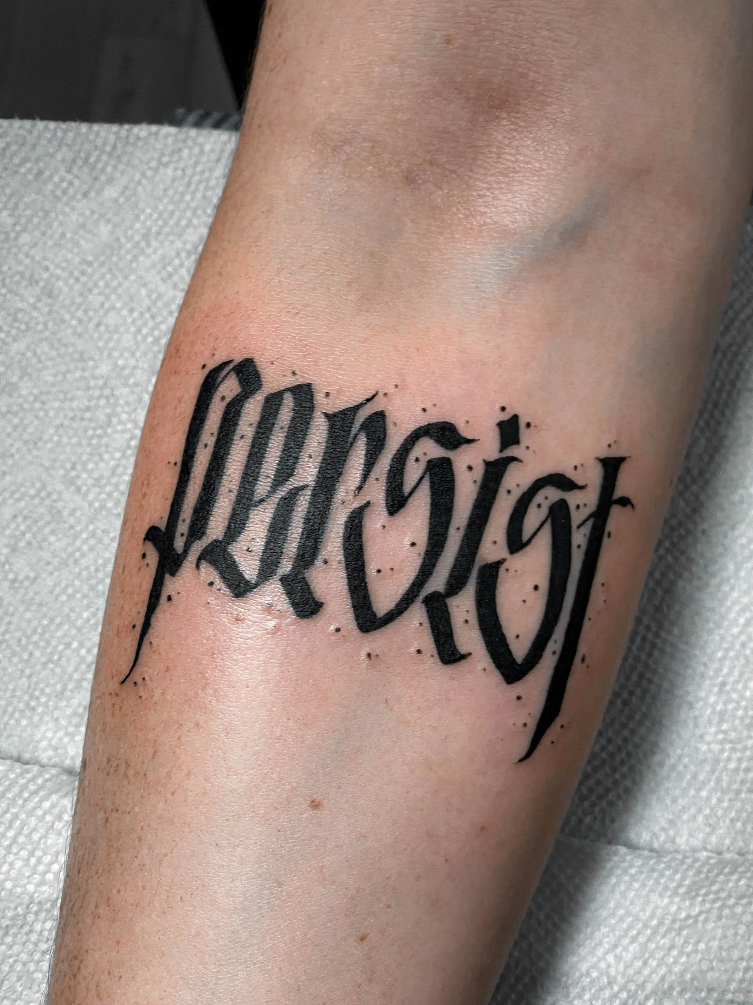 Persist - freehand calligraphy style forearm tattoo