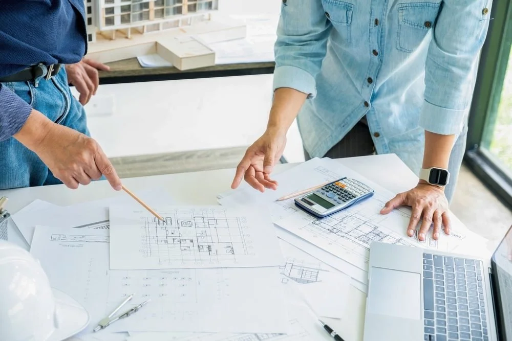 Elevating Your Lifestyle Through Thoughtful Home Design. A young engineer is talking and discussing with a senior or her boss, they are drawing graphic design of construction project plan,