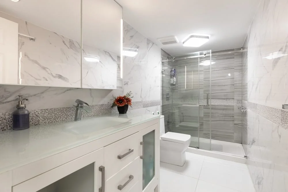 Elevating Your Lifestyle Through Thoughtful Home Design. Photoshoot Footage located in Florida, USA. Clean, modern bathroom with refreshing shower, reflecting mirror, Bathtub and sleek tiles.