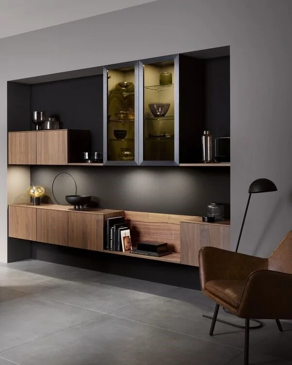 Living room niche with built-in walnut cabinets and aluminum frame glass doors