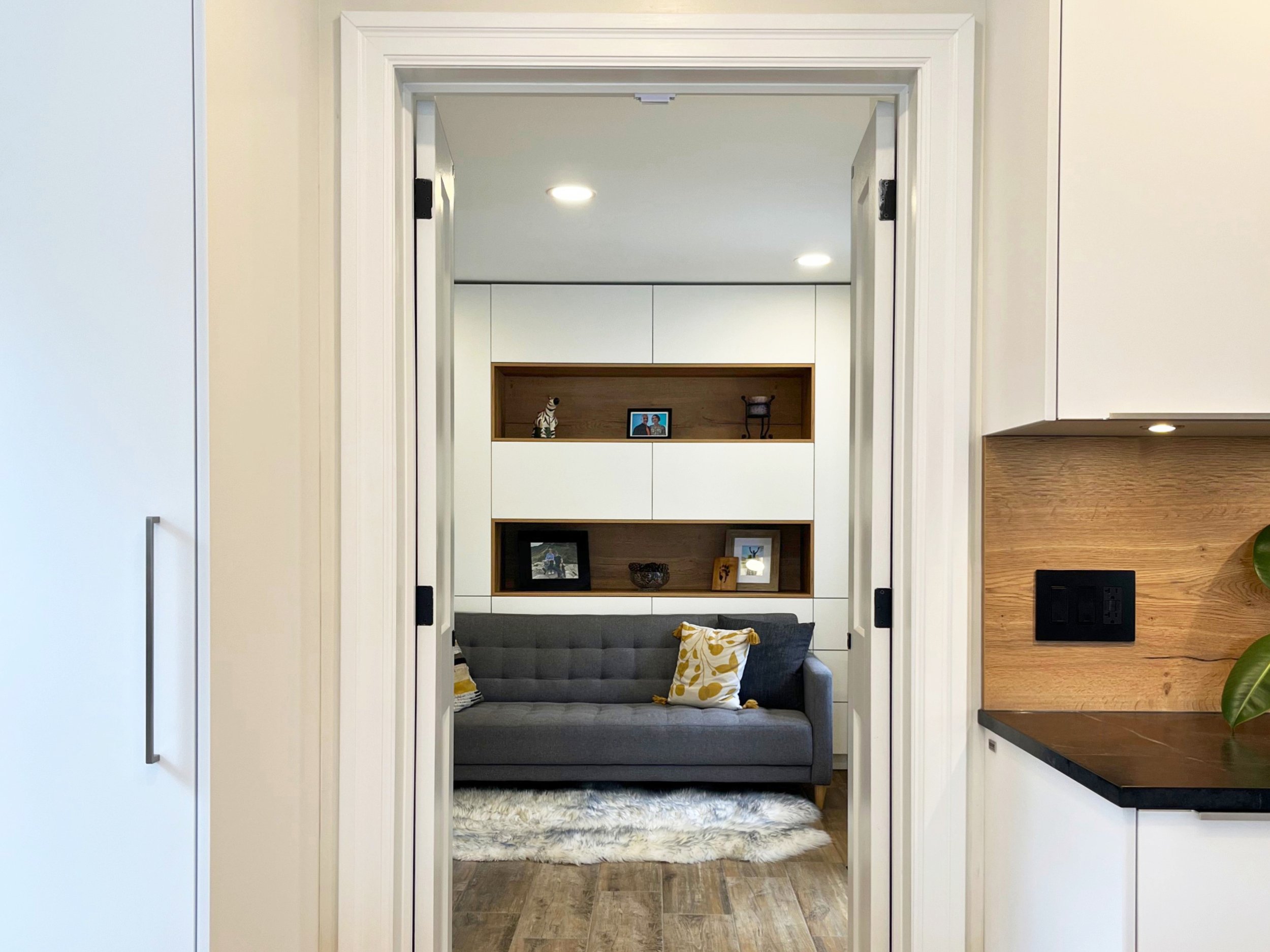 White custom built-in cabinets with wood accent shelves.