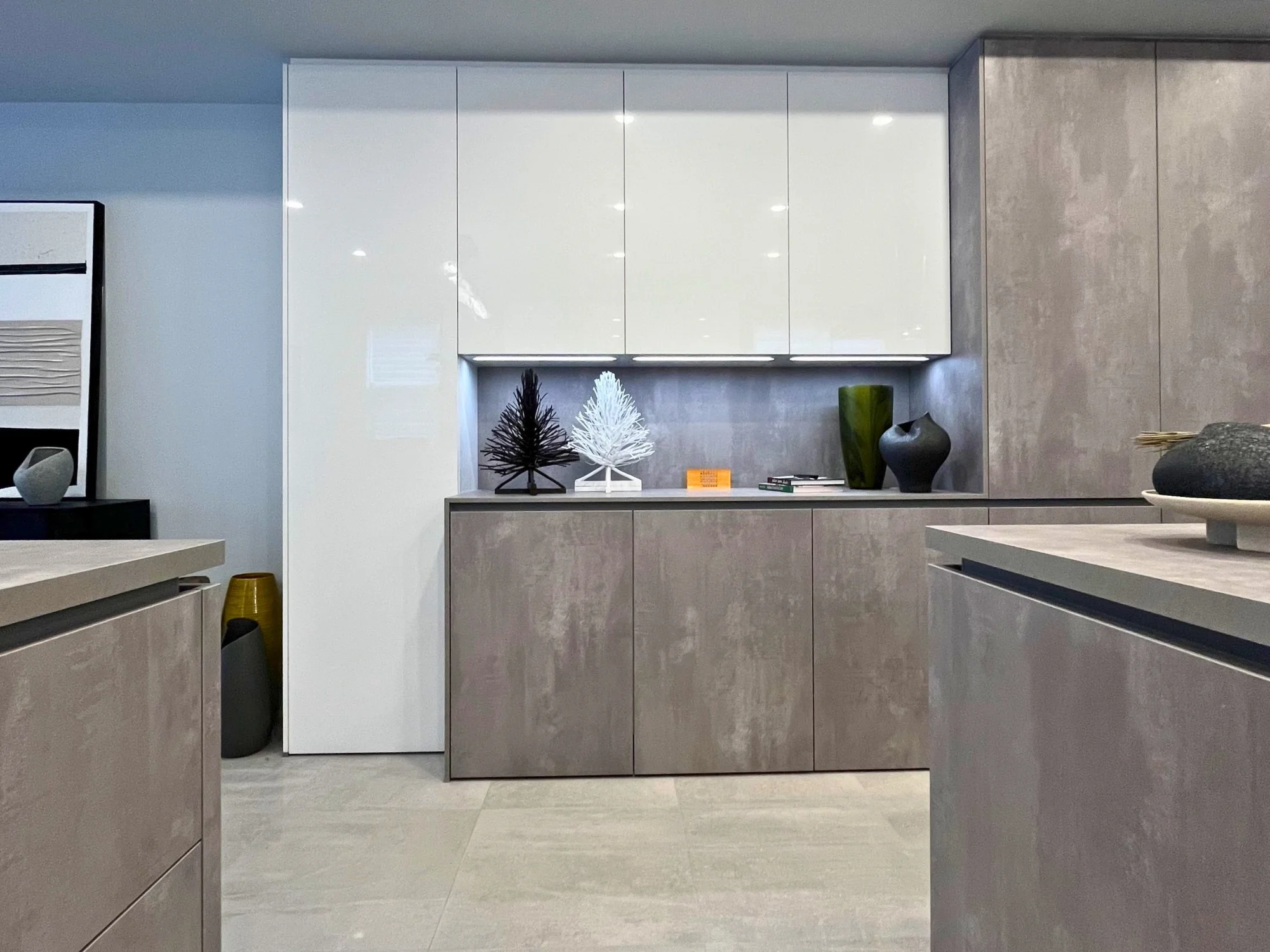 concrete textured kitchen with white surrounding cabinets