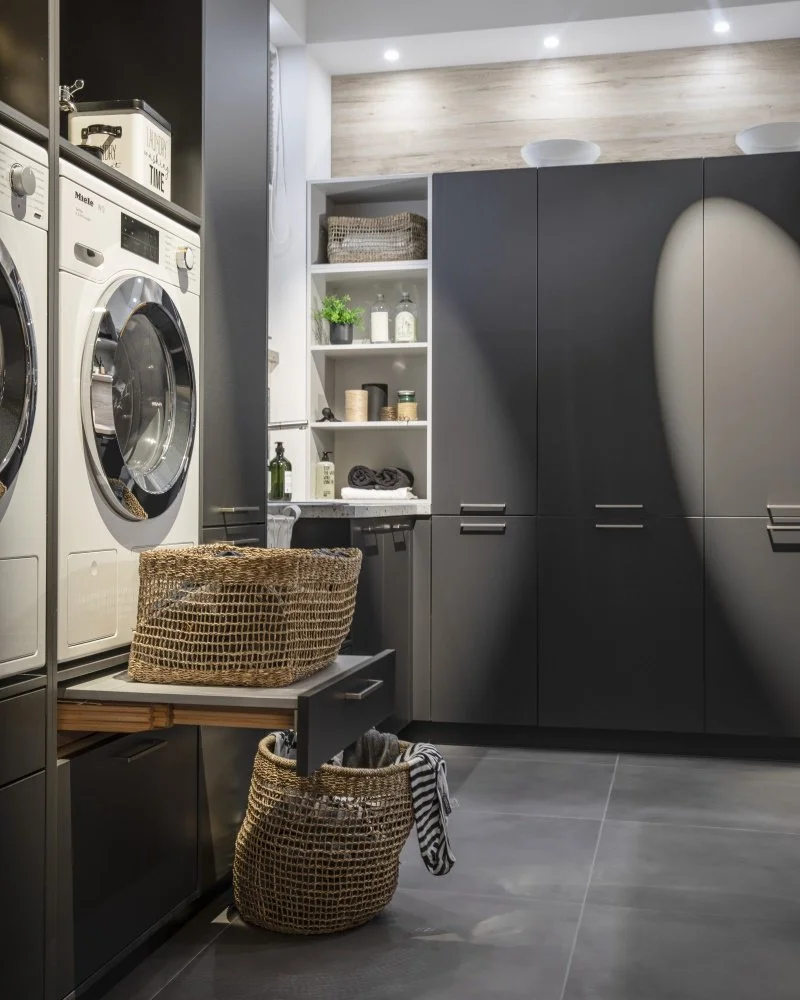 Custom laundry room cabinetry with with pull-out tray for basket