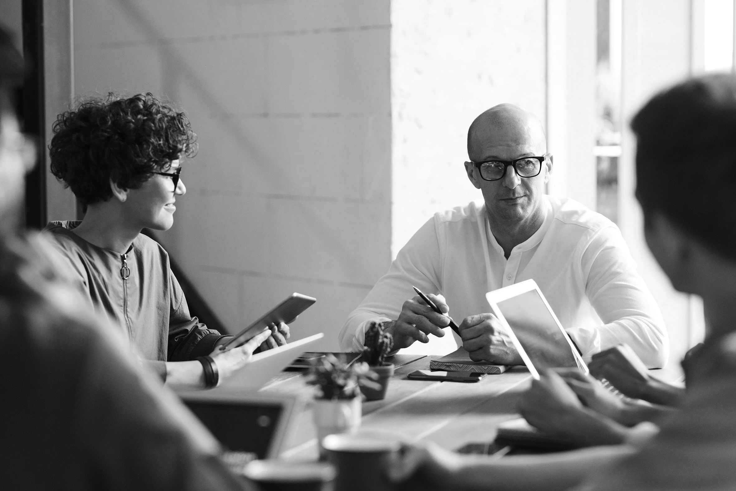 photo-of-man-sitting-in-front-of-people-3184299 black.jpg