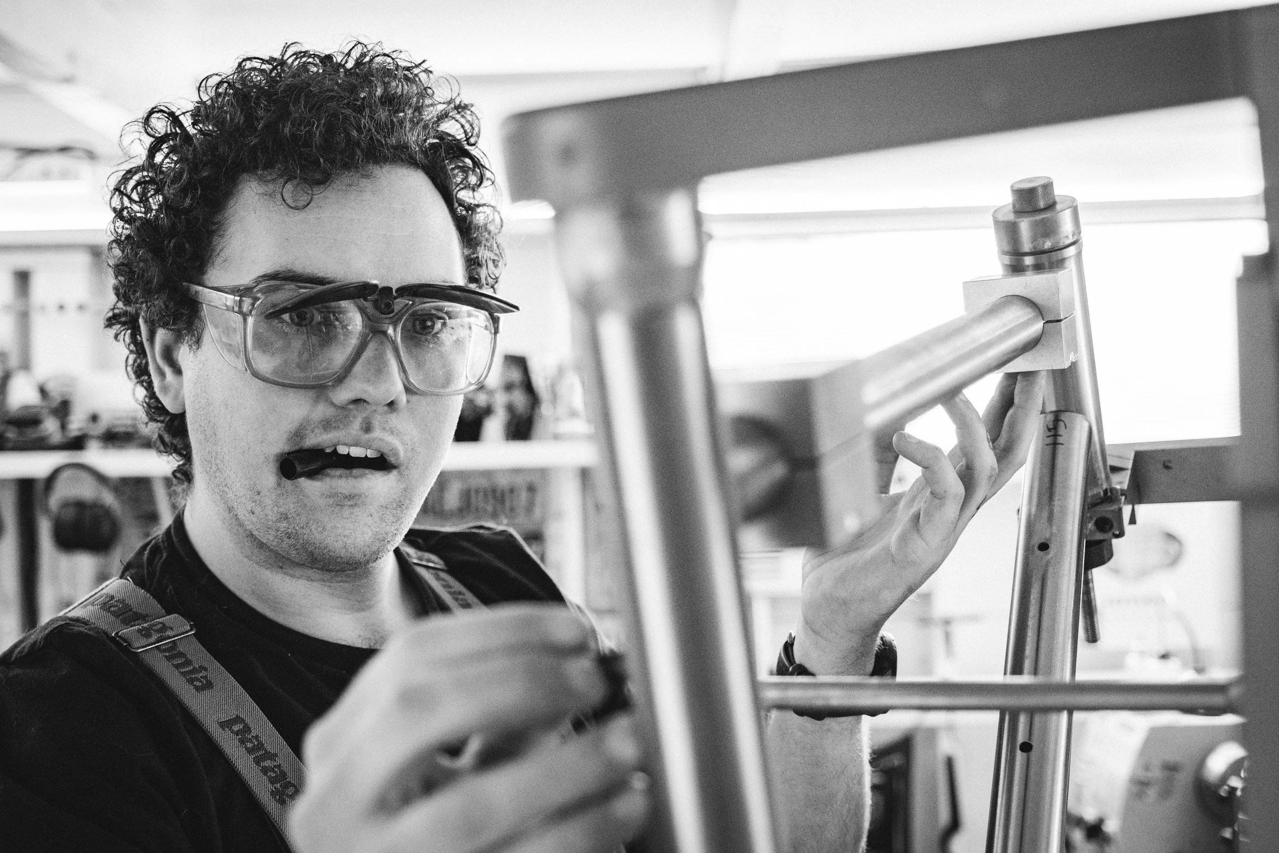 Dillen using a sharpie to mark on tubing being held in the frame jig