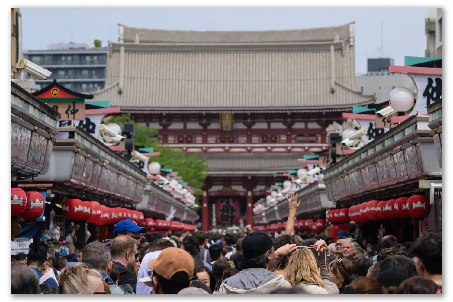 A hand waving on the shopping streets of Senso-Ji