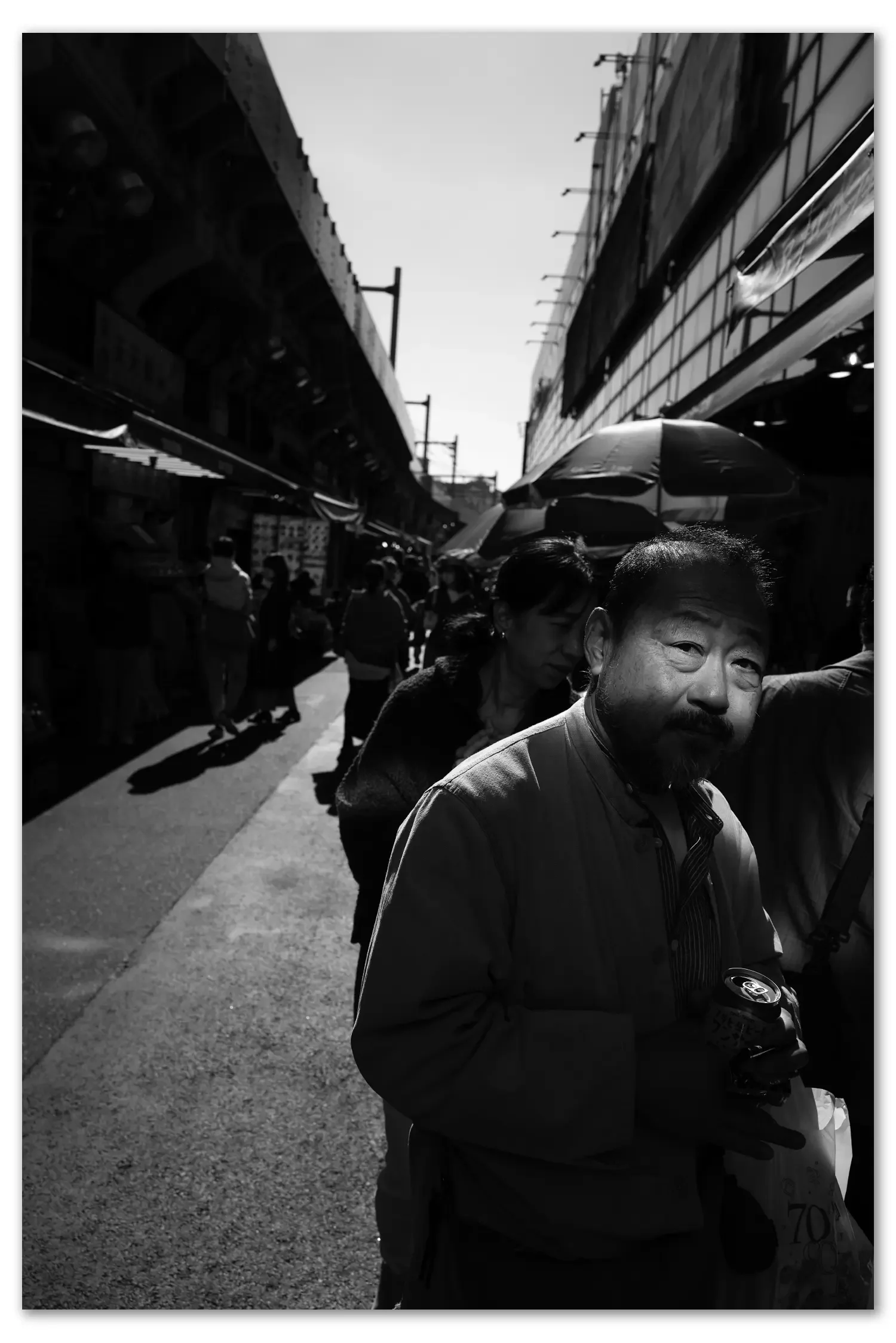 Light reflecting on to a Japanese man in Ueno Market