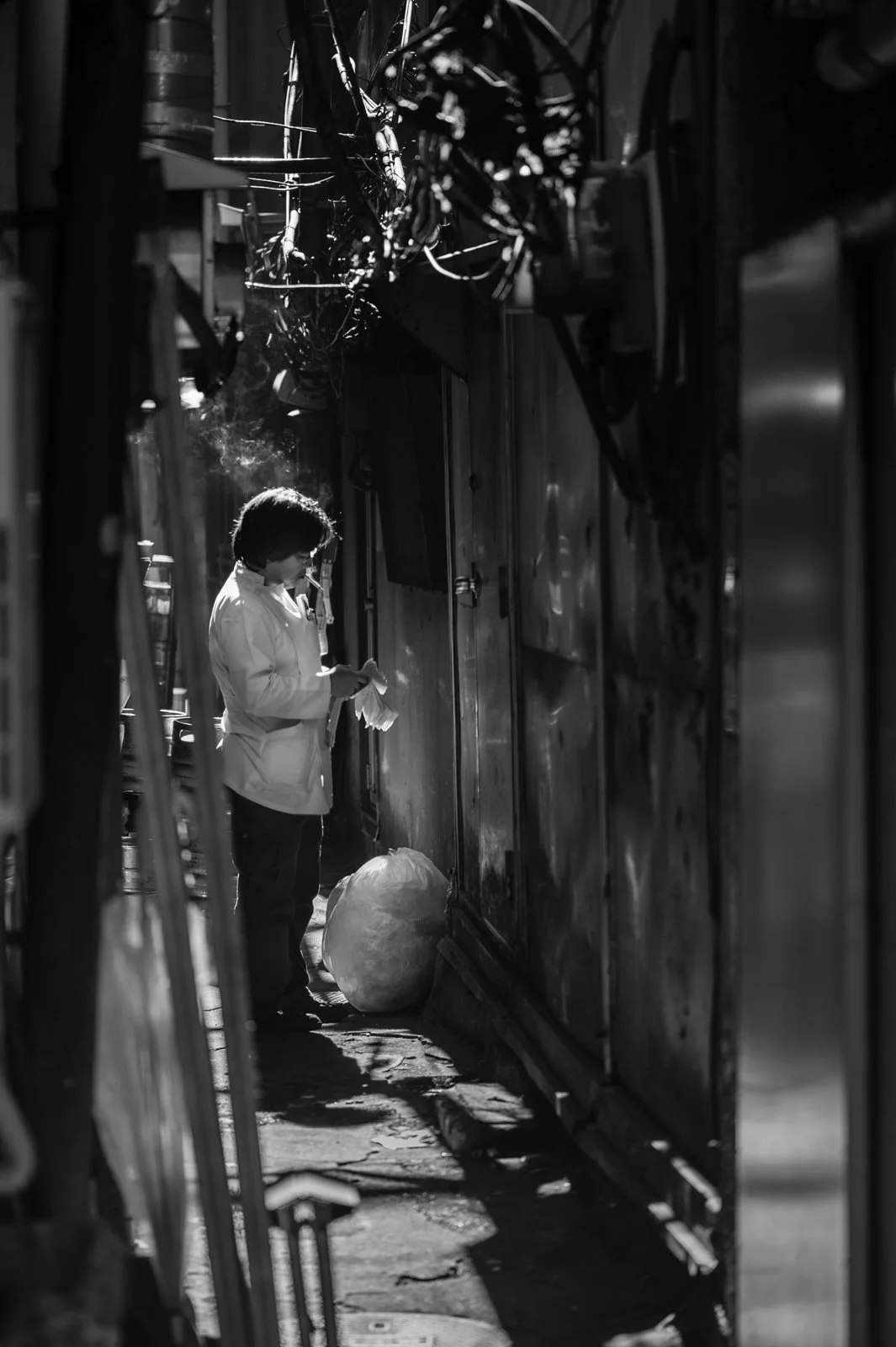 A smoke break for a chef in a Ueno Market alley