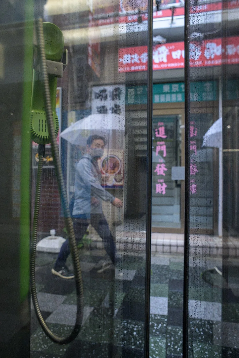 Rainy day street photography in Akabane, Tokyo. Phone booth