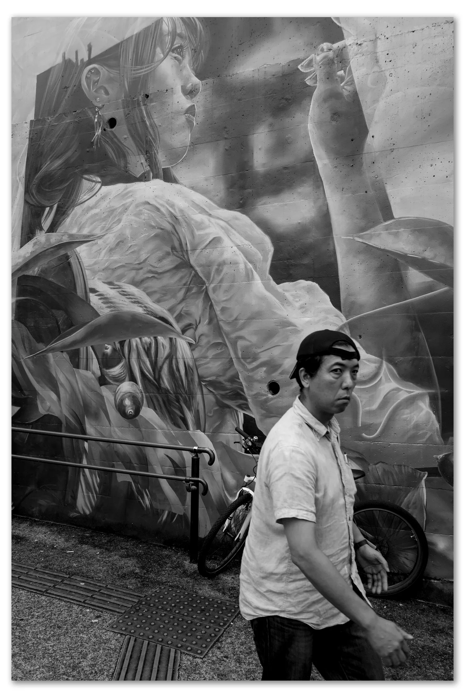 Nakano Mural by Whole9 with a middle aged man walking past